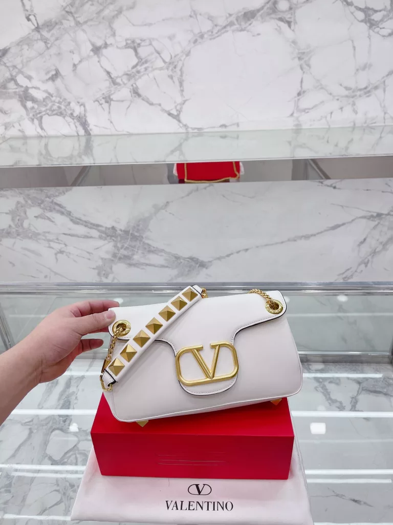 VALENTINO Women's Locò Calfskin Handbag Handbag Crossbody<br>The new Rockstud Alcove accessories collection<br>The iconic vlogo Signature is an avant-garde shape that creates a unique and seductive appeal.<br>Stud Sign Modern 