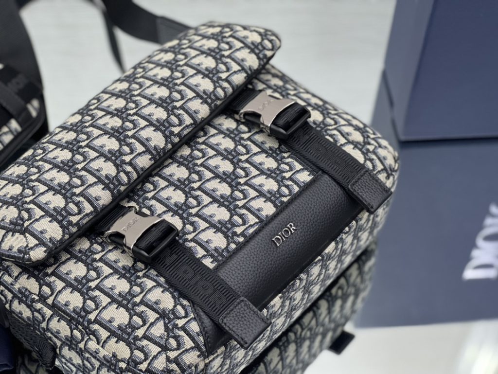 This Dior Explorer bag takes inspiration from the classic logo of the timeless messenger bag and reinterprets it in a high-staple version. Crafted in the signature beige and black Oblique print jacquard, it is accented with multiple logos and 