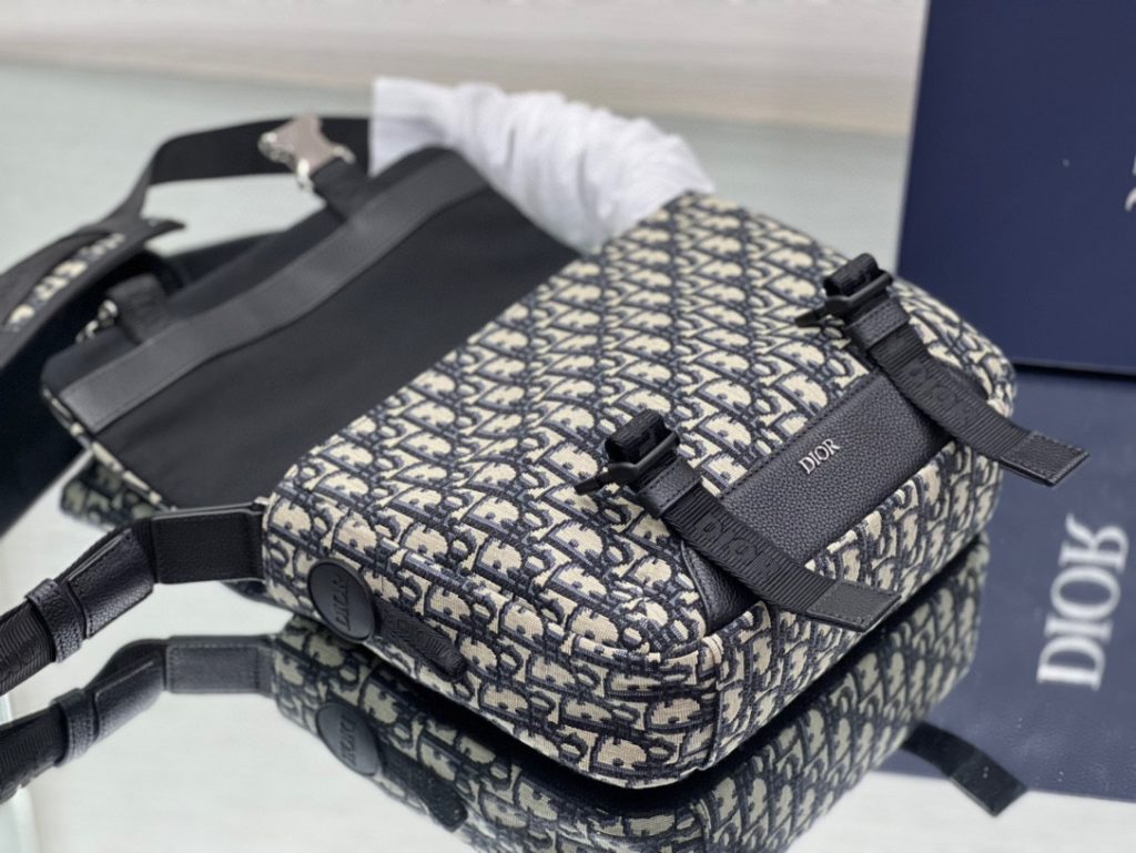 This Dior Explorer bag takes inspiration from the classic logo of the timeless messenger bag and reinterprets it in a high-staple version. Crafted in the signature beige and black Oblique print jacquard, it is accented with multiple logos and 