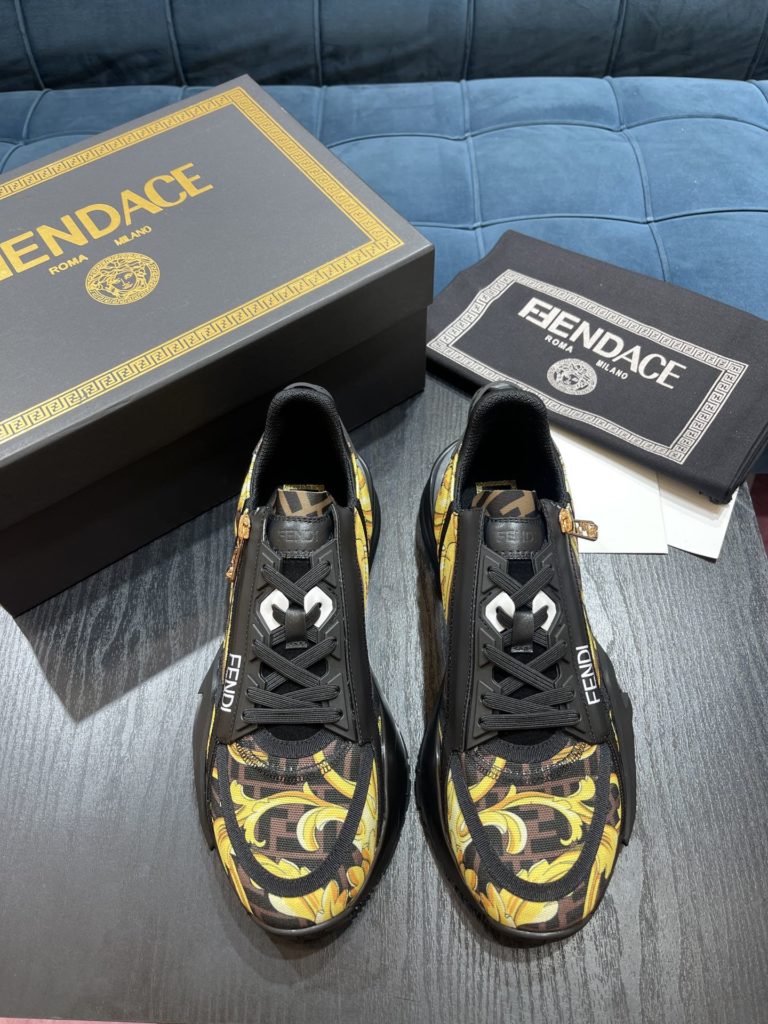 Versace by Fendi pedals sneakers with elastic laces and elastic inserts. The wavy sole is engraved with the word F. Embossed Fendi Flow on the heel. FF nylon with black and gold baroque scarf print. Lycra with FF pattern ® Tongue and Versace Medusa safety pin brooch shaped tab. Lightweight black rubber sole with diagonal F details. Made in Italy Size 39-44 (customized at 38.45)