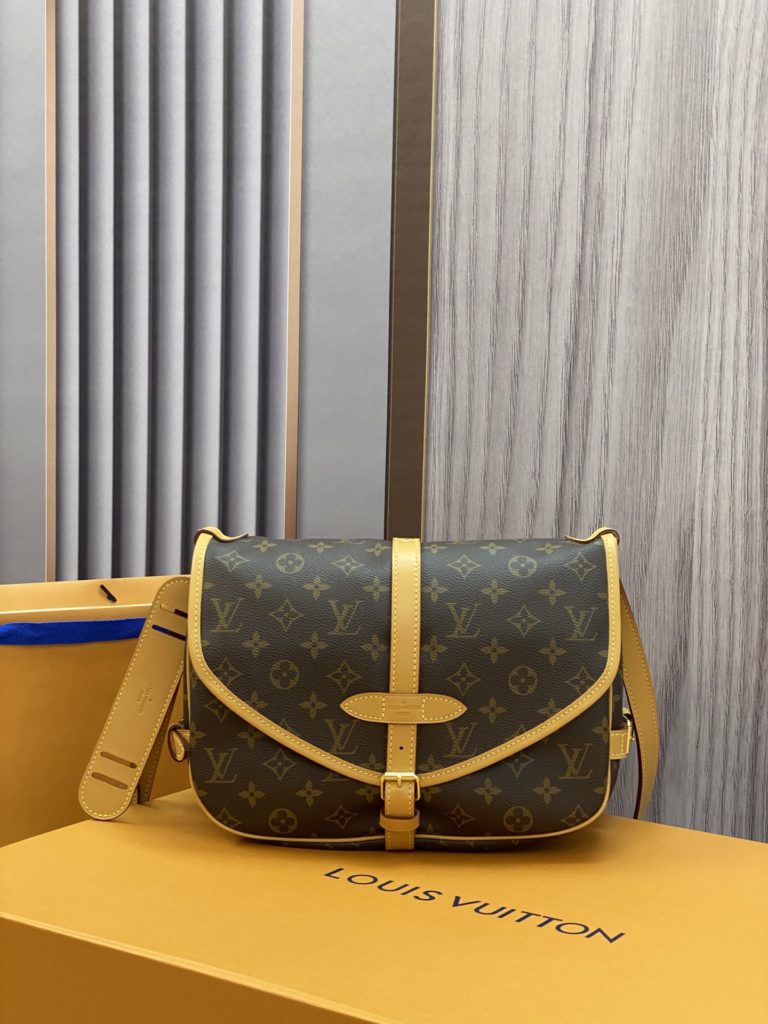 The M40710 Gemini Medieval Series SAUMUR Medium Handbag is made of Monogram canvas. The Saumur Medium Handbag demonstrates the natural elegance of Louis Vuitton. The casual cross body style is more fashionable and appealing, with delicate cowhide trim outlining a very feminine appearance. Size: 28x11x20