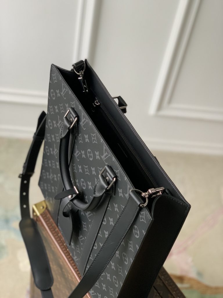 The Sac Plat handbag is made with Monogram Eclipse coated canvas to create a slim silhouette with wide lace for a trendy look in business settings. Padded interior with pockets and D-rings for easy attachment of removable shoulder straps. 36.5 x 38.0 x 9.0 cm (L x H x W)