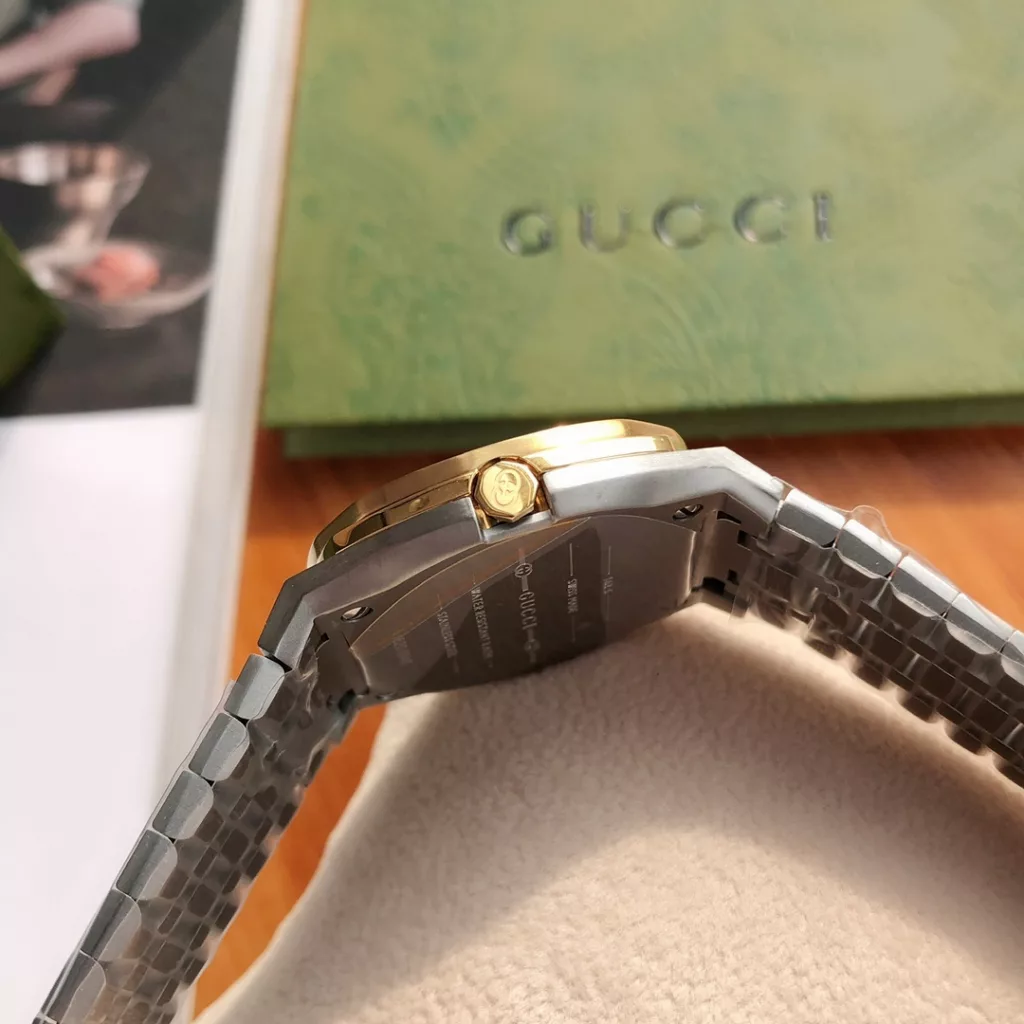 GUCCI 25H watch, streamlined design inspired by the fluid shapes of contemporary architecture, featuring a slim multi-layer case and a five-link steel bracelet with interwoven logo. 25H is named after the lucky number that meant something to creative director Alessandro Micheli. 30mm. multi-layer case in steel, silver-toned brass dial with interlocking double G motif, five-link steel bracelet, Swiss made quartz movement, water resistant to 3 ATM (30m), anti-reflective coated sapphire glass, all hardware from the original GoldFont factory, comes in a box. 5-link steel bracelet, Swiss quartz movement, water-resistant to 3 ATM (30m), sapphire glass with anti-reflective coating, all original parts from GoldFont, boxed at the back.