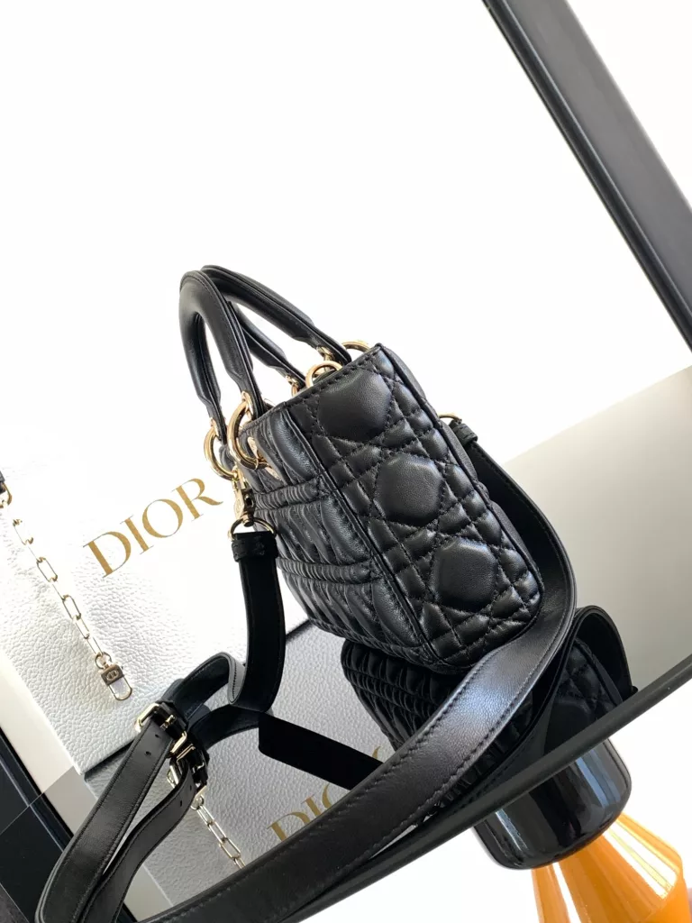 The Lady D-Joy handbag embodies Dior's profound vision of elegance and beauty. The stylish and elegant design is enduring, highlighting the simple aesthetics of Lady Dior series. Crafted in black sheep leather with rattan stitching and a light gold finish metallic D.I.O.R. Hanging raises the tone and adds a touch of flair to the exquisite silhouette. The medium style, with a detachable chain strap and an adjustable, detachable leather strap, can be carried or worn cross-body, making it ideal for everyday styling.Removable chain shoulder strapRemovable, adjustable leather shoulder strapInternal sticker bagDust bag included