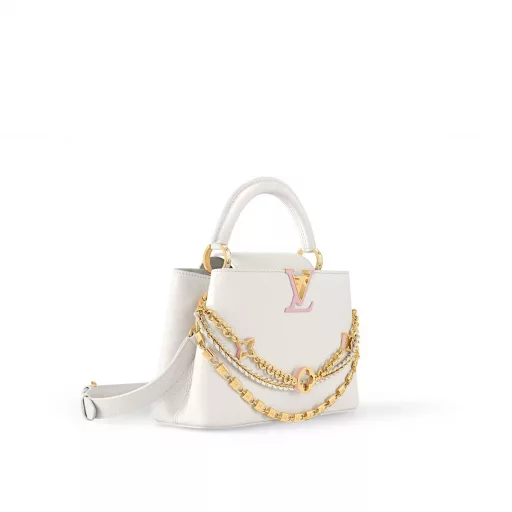 This Capucines BB bag from the Trilogy collection is elegantly crafted with Taurillon leather and striking hardware. The gorgeous chain is embellished with a mini padlock and enamel Monogram flowers, and the flap can be opened externally or internally to open multiple pockets. The sophisticated design allows for a variety of carrying experiences